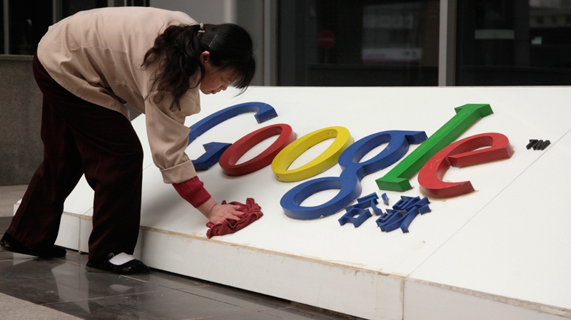 A woman cleans the Google logo outside the Google China headquarters in Beijing, China. (AP / Ng Han Guan)