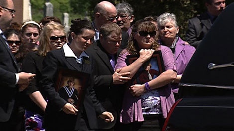 The family of Eric Leighton comforts each other at his memorial service Friday, June 3, 2011.