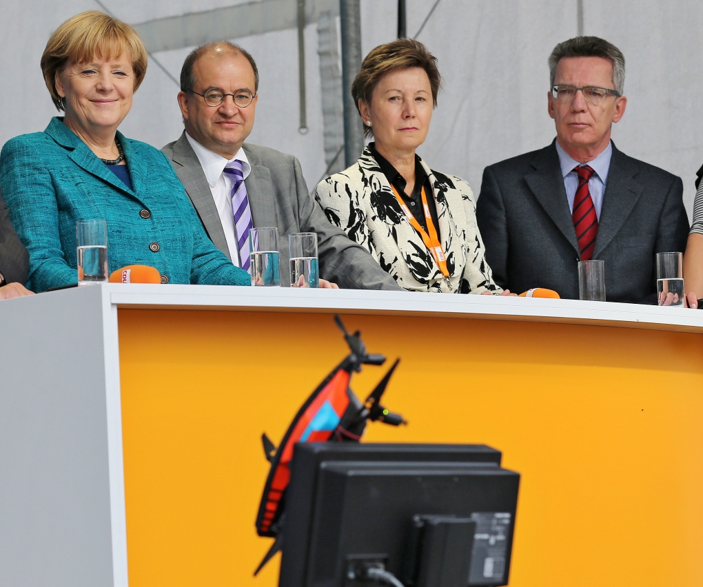 Chancellor Angela Merkel looks at a camera drone 