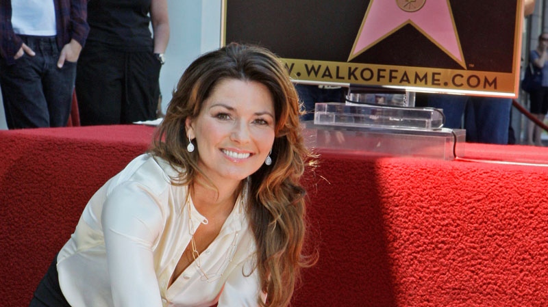 Shania Twain, the Canadian singer who is the top-selling female country artist of all time, touches her new star of the Hollywood Walk of Fame at dedication ceremonies in Los Angeles, Thursday, June 2, 2011. (AP / Reed Saxon) 