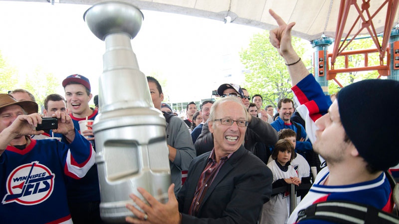 Mayor Sam Katz holds a plastic Stanley Cup as Winnipeg hockey supporters rally following the announcement that an NHL team will be returning to the city after 15 years on Tuesday, May 31, 2011. (David Lipnowski / THE CANADIAN PRESS)