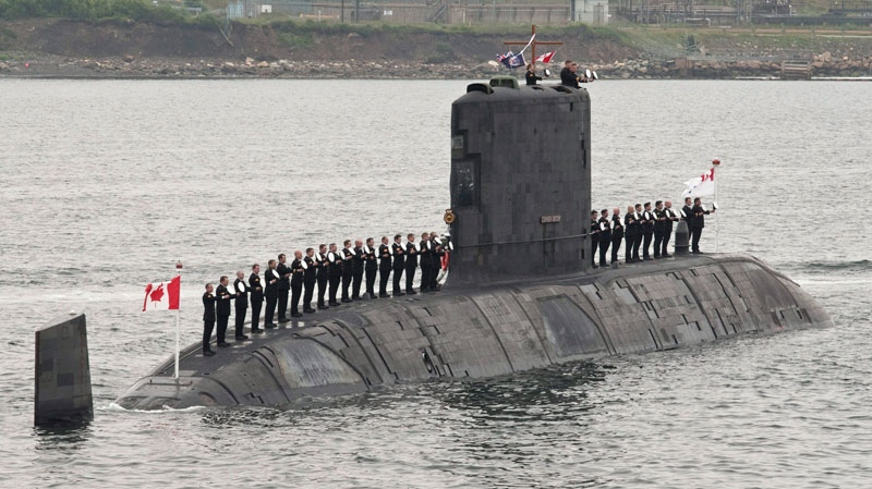 Sailors line up on Canadian submarine HMCS Corner Brook to salute Queen Elizabeth II during an international fleet review Tuesday, June 29, 2010 in Halifax. (Paul Chiasson/CP)