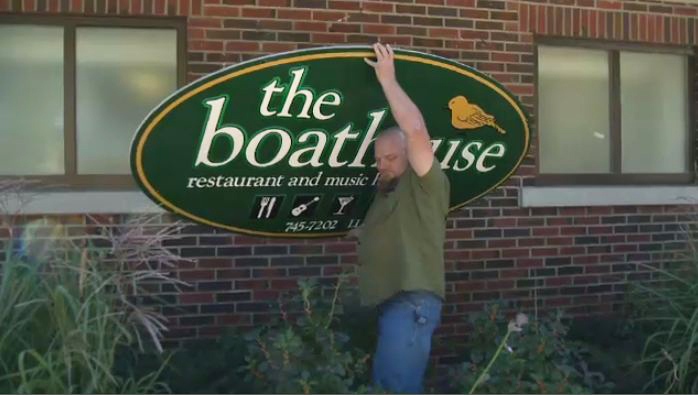 Kevin Doyle removes a sign from the outside of the Boathouse in Kitchener, Ont., on Monday, Sept. 16, 2013.