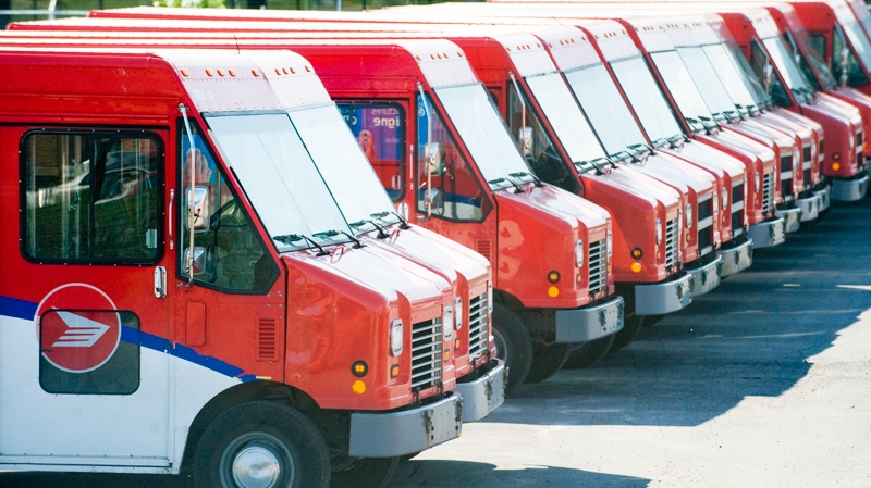 Canada Post vehicles sit idle outside a sorting depot in the borough of Ville St. Laurent in Montreal, Monday, June 6, 2011. (Graham Hughes / THE CANADIAN PRESS)