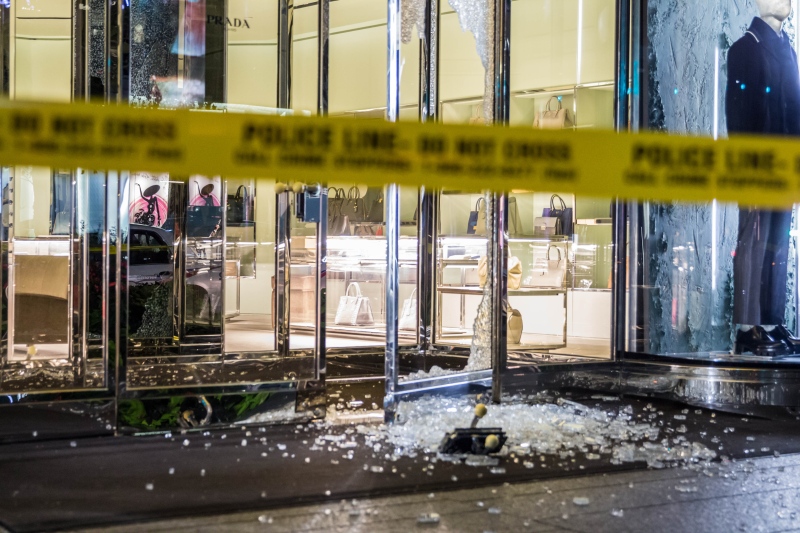 Police investigate a smash-and-grab robbery at a Prada store on Bloor Street West early Wednesday, Sept. 18, 2013. (Tom Stefanac / CP24)