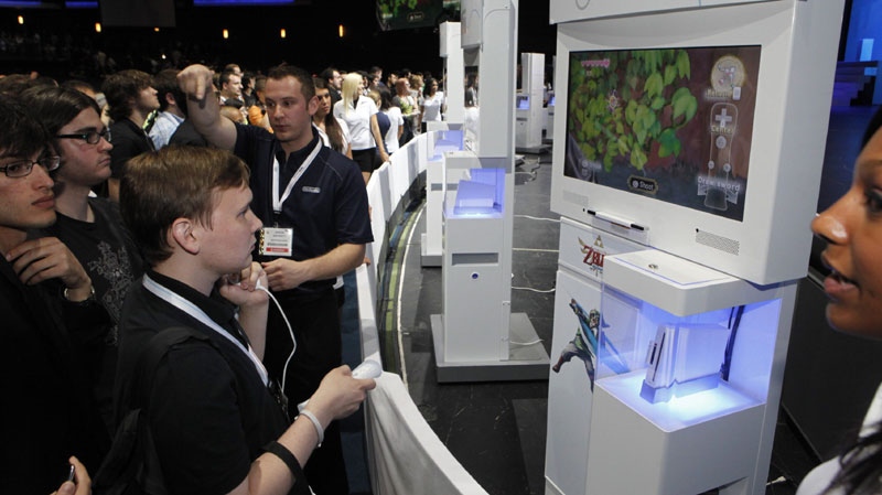 James Jones, Nintendo World Report, plays the new "Legend of Zelda" on a Wii game console during Nintendo's E3 presentation at the Nokia Theatre LA LIVE, Tuesday, June 15, 2010, in Los Angeles. (AP Photo/Damian Dovarganes)