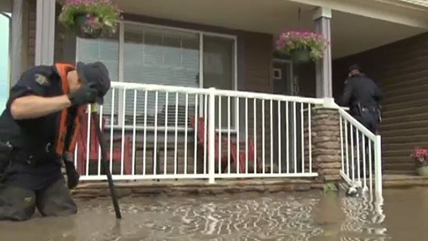 Police search homes in High River