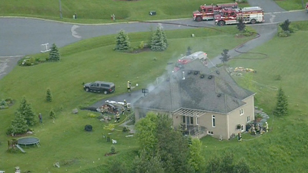 Fire crews extinguish a house fire in Caledon, reportedly caused by a bolt of lightning, Tuesday, June 7, 2011.