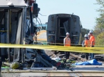 6 people killed after bus and train collide in Ottawa<br><br>
Officials investigate at the scene of a Via Rail train and city bus collision in Ottawa's west end Wednesday, Sept. 18, 2013. Six people died and more than 30 were injured when the bus slammed into the train after going through a safety barricade. (Adrian Wyld / THE CANADIAN PRESS)