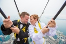 Canadian couple John Kirk and Lacy Boland wed hanging off the edge of the CN Tower, 116 storeys above ground. (EdgeWalk / Red Andal)