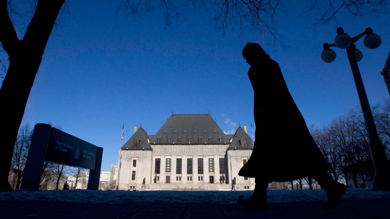 A pedestrian is shown walking past the Supreme Court of Canada in Ottawa, Wednesday Feb. 23, 2011. (Adrian Wyld / THE CANADIAN PRESS)