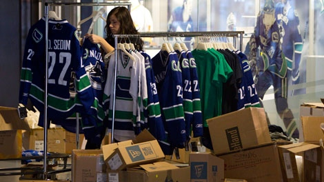 An employee at the Vancouver Canucks store unpacks merchandise at Rogers Arena Friday, May 27, 2011. Marketing is about connecting people to products and services, and one marketing analyst says when it comes to marketing its products, the Vancouver Canucks get it. THE CANADIAN PRESS/Jonathan Hayward