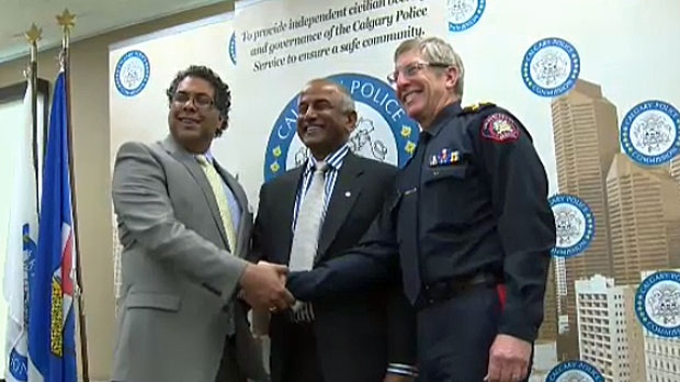 Mike Shaikh is seen here with the police chief and mayor of Calgary. 