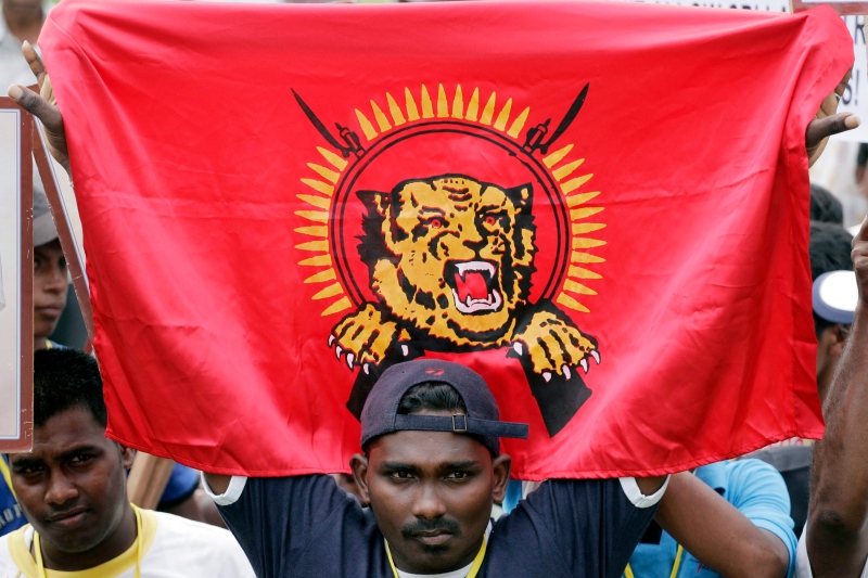 A Malaysian protester of Tamil ethnicity holds a flag of Liberation Tigers of Tamil Eelam (LTTE) during a demonstration in this 2009 file photo. (AP Photo/Lai Seng Sin) 