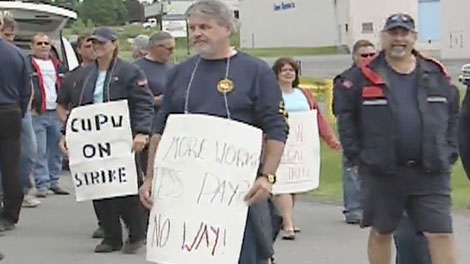 Canada Post workers walk the picket line in Cornwall, joining workers in nine other cities participating in rotating strikes, Monday, June 13, 2011.