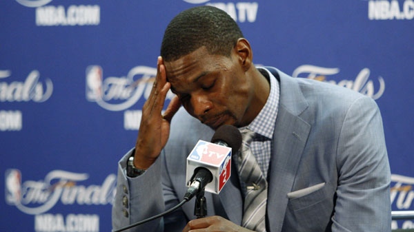 Miami Heat's Chris Bosh holds his head down during a news conference after Game 6 of the NBA Finals basketball game against the Dallas Mavericks Sunday, June 12, 2011, in Miami. The Mavericks won 105-95 to win the series. (AP Photo/Wilfredo Lee) 
