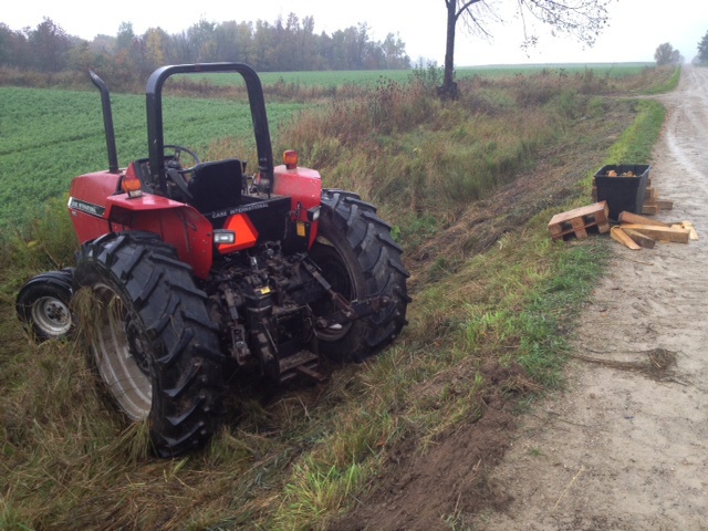 A tractor sits at the side of the road following a fatal rollover crash near Drayton, Ont., on Monday, Sept. 30, 2013. (Kevin Doerr / CTV Kitchener)
