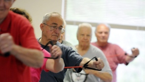Fitness instructor Fran Tabor leads a men's group exercise class at the Senior Resource Center in Wilmington, N.C. Wednesday, April 18, 2012. (AP Photo/The Star-News, Mike Spencer) 