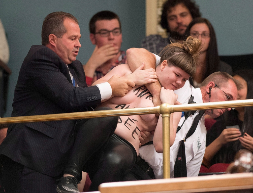 Topless activist storms Quebec legislature