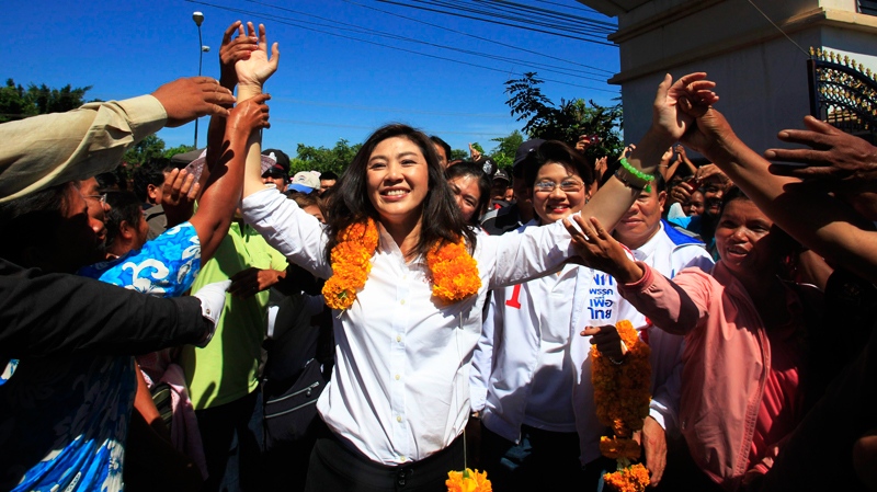 Yingluck Shinawatra, centre, opposition Pheu Thai Party's candidate for prime minister and sister of ousted Prime Minister Thaksin Shinawatra, is greeted by her supporters during an election campaign for her party in Ubonratchathani province, northeast of Bangkok, Thailand Wednesday, June 15, 2011.  (AP / Sakchai Lalit)