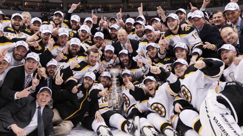 The Boston Bruins pose for a team photo as they celebrate their win over the Vancouver Canucks in game 7 of NHL Stanley Cup Final hockey at Rogers Arena in Vancouver, Wednesday, June 15, 2011. (Jonathan Hayward / THE CANADIAN PRESS)