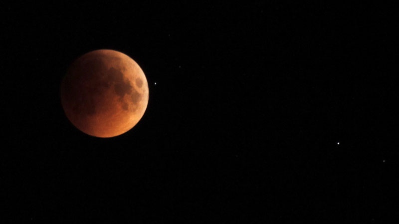 The moon turns red during a total lunar eclipse as seen in Srinagar, India, early Thursday, June 16, 2011. The total lunar eclipse was also visible in most parts of Asia. 