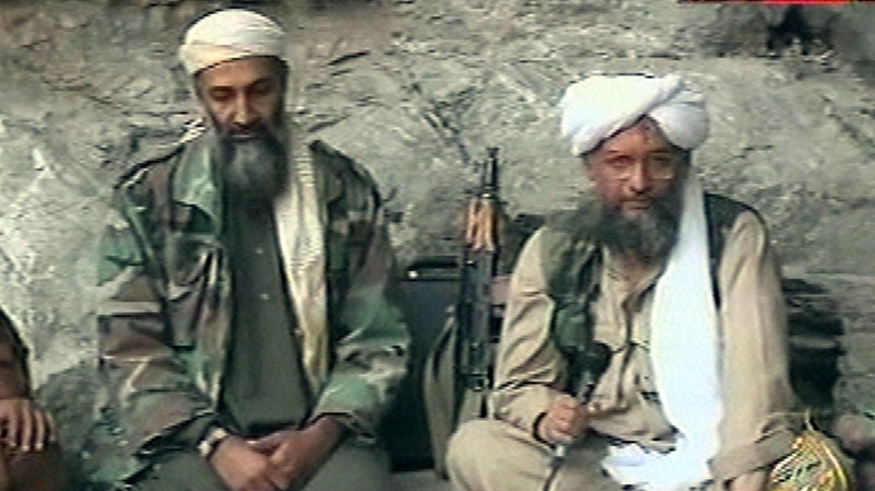 Osama bin Laden, left, and his top lieutenant Egyptian Ayman al-Zawahri, right, are seen at an undisclosed location in this television image broadcast, Oct. 7, 2001. (AP / Al-Jazeera)