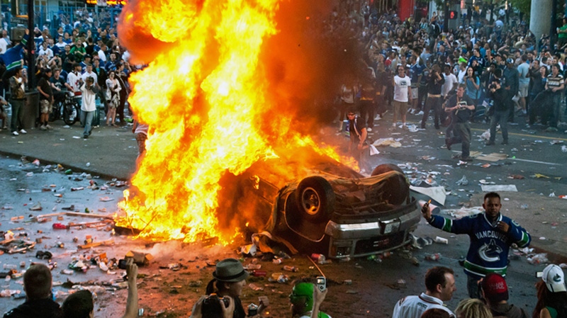 MyNews contributor Adrian Geromimo captured this photo of a truck on fire after being overturned by rioters following game 7 of the NHL Stanley Cup final in downtown Vancouver on Wednesday, June 15, 2011. (Adrian Geronimo / MyNews.CTV.ca)