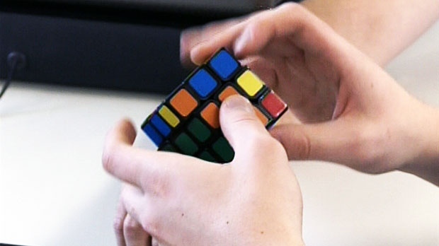 Man tries to solve Rubik’s cube
