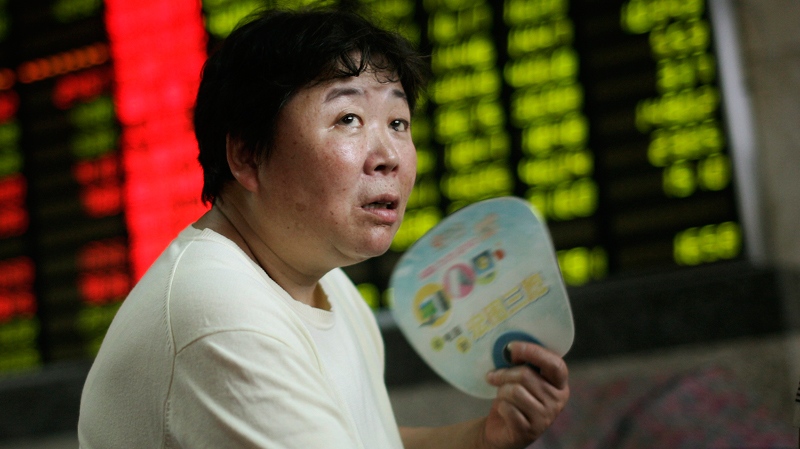 An investor looks at the stock price board at a private securities company in Shanghai, China, Friday June 17, 2011. (AP)