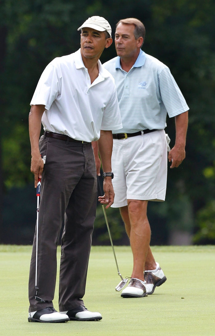 President Barack Obama and House Speaker John Boehner, R-Ohio, are on the first green as they play golf at Andrews Air Force Base, Md., Saturday, June 18, 2011. (AP Photo/Charles Dharapak)