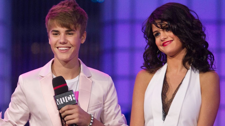 Justin Bieber and girlfriend Selena Gomez stand on stage during the 2011 MuchMusic Video Awards in Toronto on Sunday, June 19, 2011. (Darren Calabrese / THE CANADIAN PRESS)