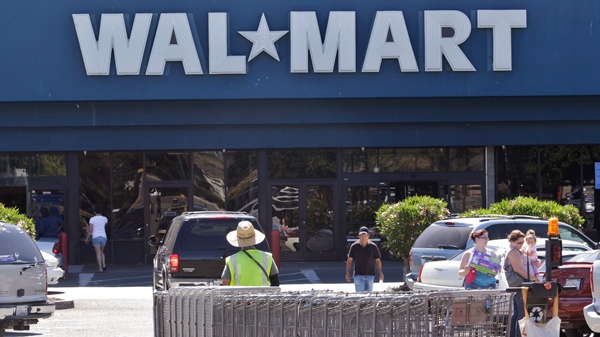 A Wal-Mart worker pull carts at a Wal-Mart store in Pittsburg Calif., Monday, June 20, 2011. (AP / Paul Sakuma)