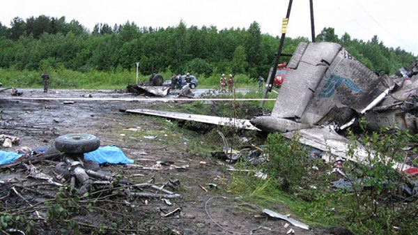 In this photo provided by Russia Emergency Situations Ministry press service, wreckage of Tu-134 plane, belonging to the RusAir airline, is seen on a highway near the city of Petrozavodsk Tuesday, June 21, 2011. (Ministry of Emergency Situations press service)