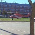 An Ornge air ambulance lands on a soccer field at Wilfrid Laurier University in Waterloo, Ont., on Friday, Oct. 11, 2013. (Courtesy @CashFlowIsKey / Twitter)