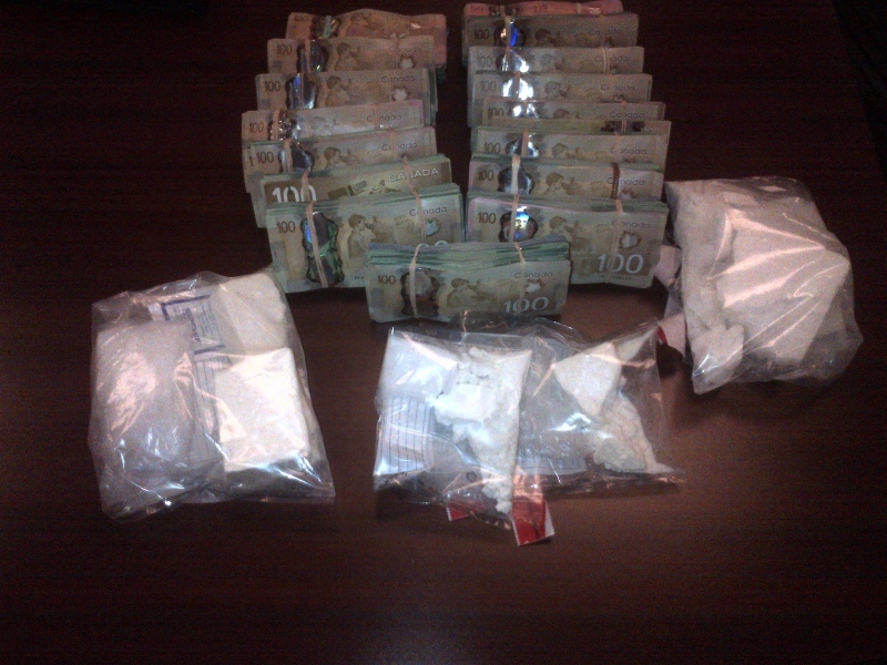 London police display drugs and cash seized after raids on four locations in the city, Thursday, Oct. 10, 2013.