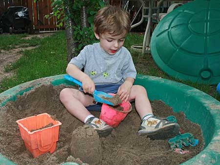 Two-year-old Shane plays in a sandbox in Oakville, Ont. (THE CANADIAN PRESS/ Richard Buchan)