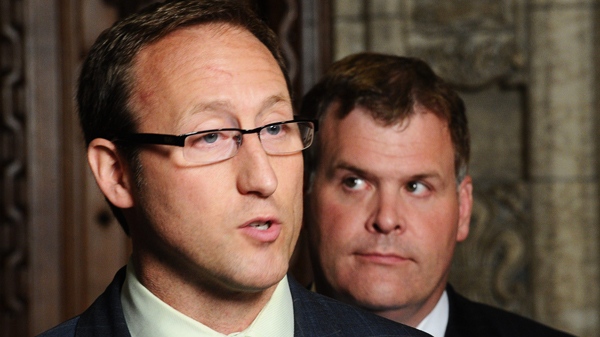 Minister of Foreign Affairs John Baird, right, and Minister of Defence Peter MacKay speak to reporters in the foyer of the House of Commons regarding the tabling of documents relating to Canadian-transferred detainees in Afghanistan on Parliament Hill in Ottawa on Wednesday, June 22, 2011. (Sean Kilpatrick / THE CANADIAN PRESS)