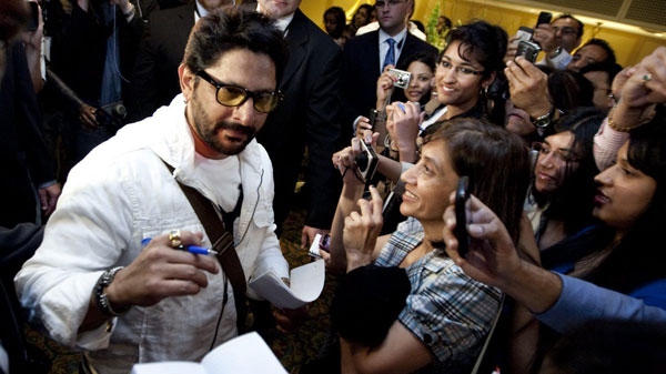 Bollywood star Arshad Warsi is surrounded by bodyguards while signing autographs for fans in Toronto Wednesday, June 22, 2011. Bollywood takes over Toronto with a weekend of music, fashion, film and dance, culminating in a star-studded awards bash Saturday. THE CANADIAN PRESS/Darren Calabrese