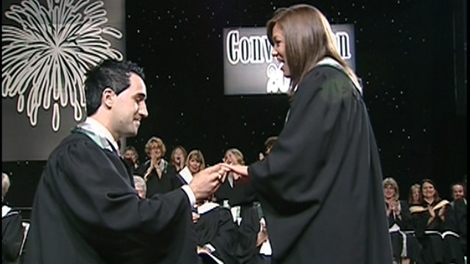 Jacob Sancartier interrupts his girlfriend's graduation ceremony to ask Janice Marie for her hand in marriage, Wednesday, June 22, 2011.