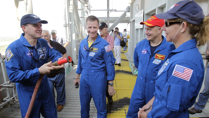 Space shuttle Atlantis crew members, from left, mission specialist Rex Walhiem, commander Chris Ferguson, pilot Doug Hurley and mission specialist Sandy Magnus share a light moment during emergency safety training during the Terminal Countdown Demonstration Test at the Kennedy Space Center in Cape Canaveral, Fla., Wednesday, June 22, 2011. (AP Photo/John Raoux, Pool)