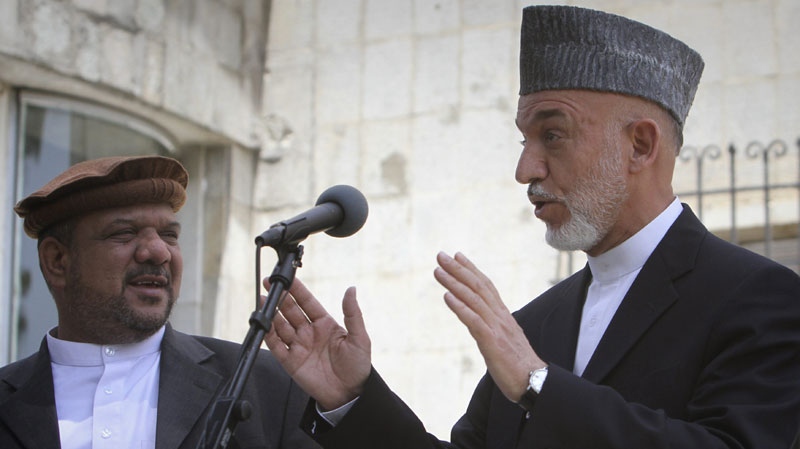 Afghan President Hamid Karzai speaks, as his first voice president Qasim Fahim looks on him during a press event at the presidential palace in Kabul, Afghanistan on Thursday, June 23, 2011. (AP Photo/Musadeq Sadeq)