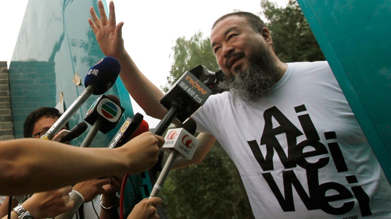 Activist artist Ai Weiwei opens the gate to talk to journalists gathered outside his home in Beijing, China, Thursday, June 23, 2011. (AP / Ng Han Guan)