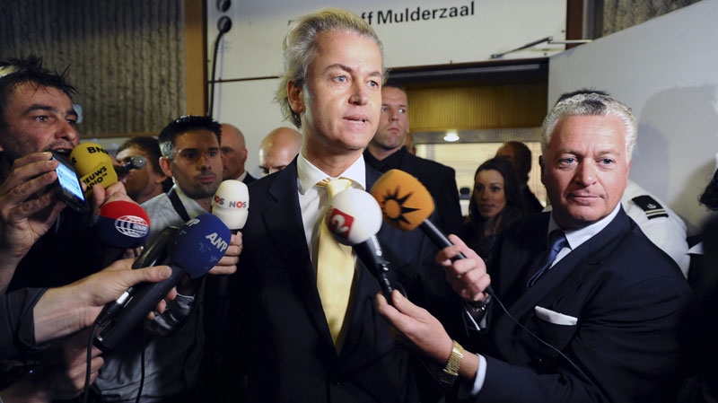 Right-wing politician Geert Wilders and his lawyer Bram Moszkowicz, right, as Wilders gives a brief statement after A Dutch court acquitted him of hate speech and discrimination in Amsterdam, Thursday June 23, 2011. (AP Photo/Evert Elzinga)