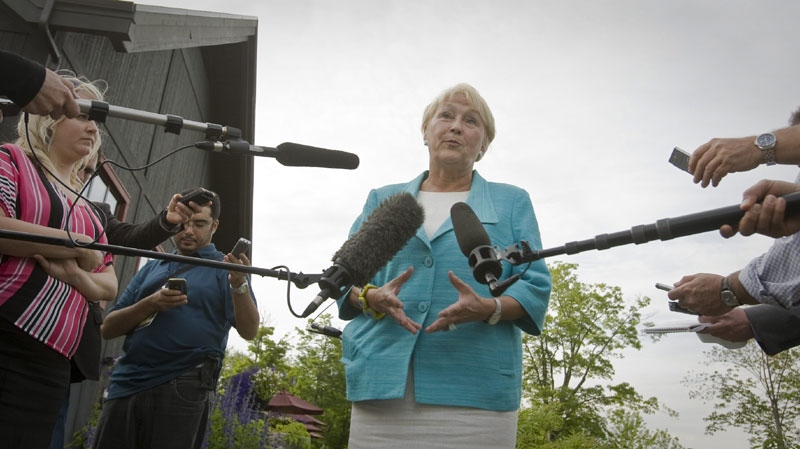 Parti Quebecois leader Pauline Marois gestures as she speak during a press conference at Dushesnay Conservation centre in Sainte-Catherine-de-la-Jacques-Cartier, just north of Quebec city, Wednesday June 22, 2011. (THE CANADIAN PRESS/Francis Vachon)