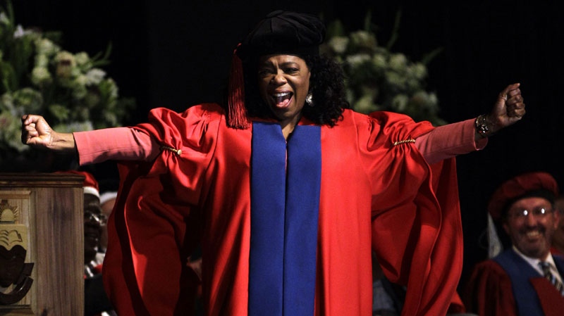 Oprah Winfrey reacts as she receives an honorary doctorate in education from Prof. Dennis Francis, unseen, during her graduation ceremony at the Free State University in Bloemfontein, South Africa, Friday, June 24, 2011. (AP Photo/Themba Hadebe)