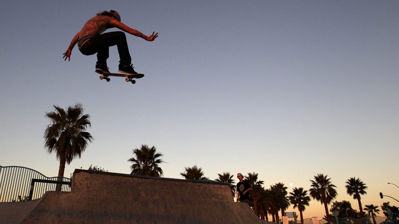 FILE - A skateboarder catches air on his skateboard at a skate park on Tuesday, Jan. 18, 2011, in San Diego. 