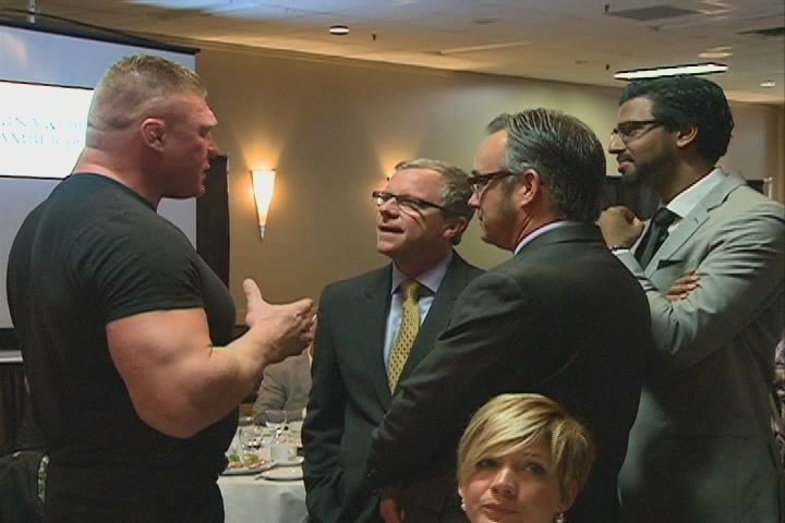 Former UFC champ Brock Lesnar talks with Premier Brad Wall (centre) during an event Thursday in Regina.
