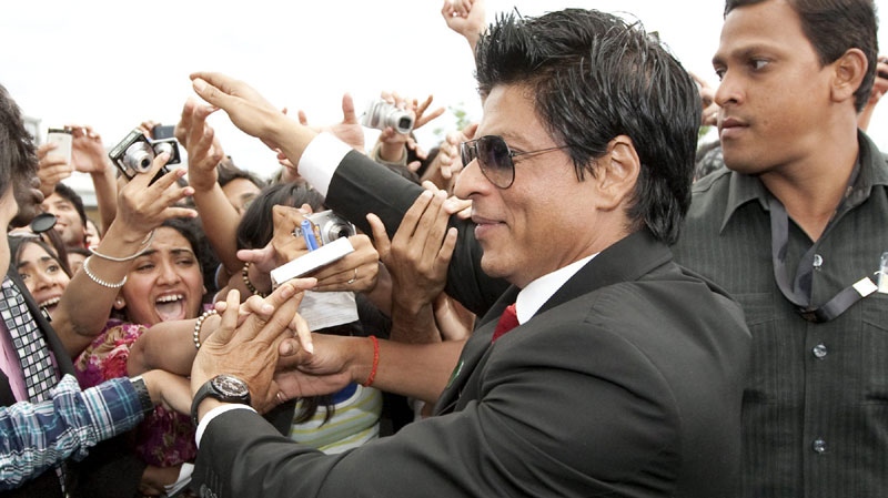 Bollywood actor Shahrukh Khan is mobbed by fans while arriving the IIFA Rocks event during the 2011 International Indian Film Academy in Toronto on Friday, June 24, 2011. THE CANADIAN PRESS / Darren Calabrese