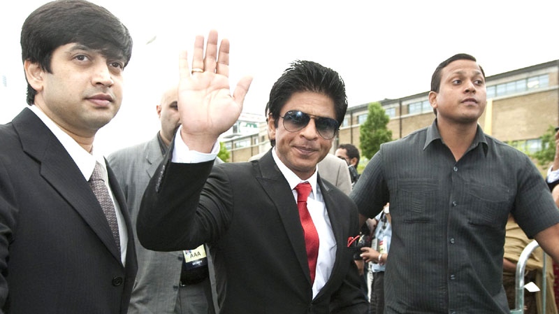 Indian film superstar Shahrukh Khan, centre, is surrounded by bodyguards while arriving at the IIFA Rocks event during the 2011 International Indian Film Academy in Toronto on Friday, June 24, 2011. THE CANADIAN PRESS / Darren Calabrese